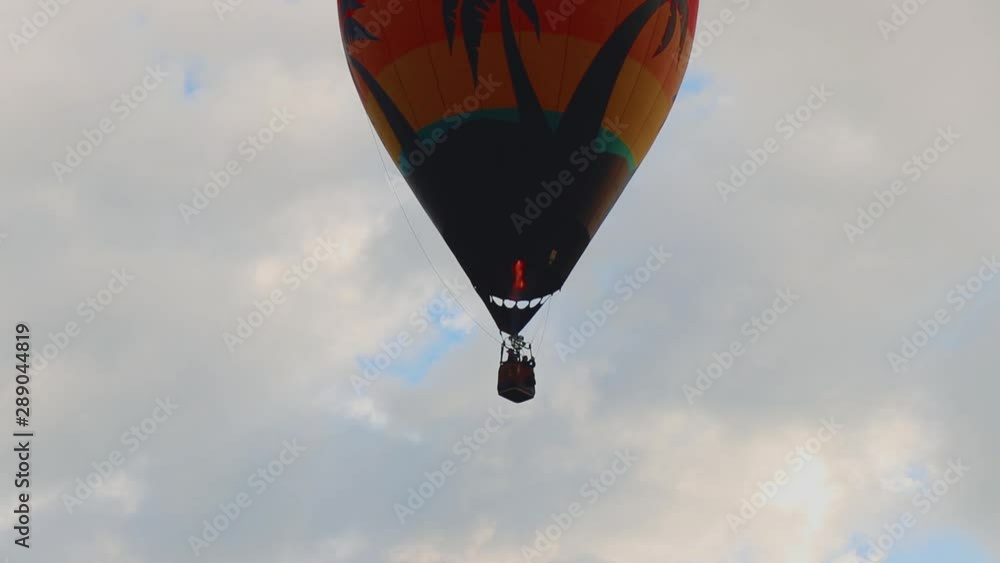 Silhouette Of Hot Air Balloon With Flames Rising Into The Air Against Blue Sky 10 Second Video. Silhouette Of Hot Air Balloon With Flames Rising Into The Air Against Blue Sky 10 Second Video.