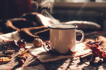 Autumn hot steaming cup of coffee or tea.