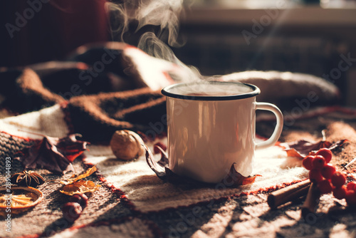 Autumn hot steaming cup of coffee or tea. photo