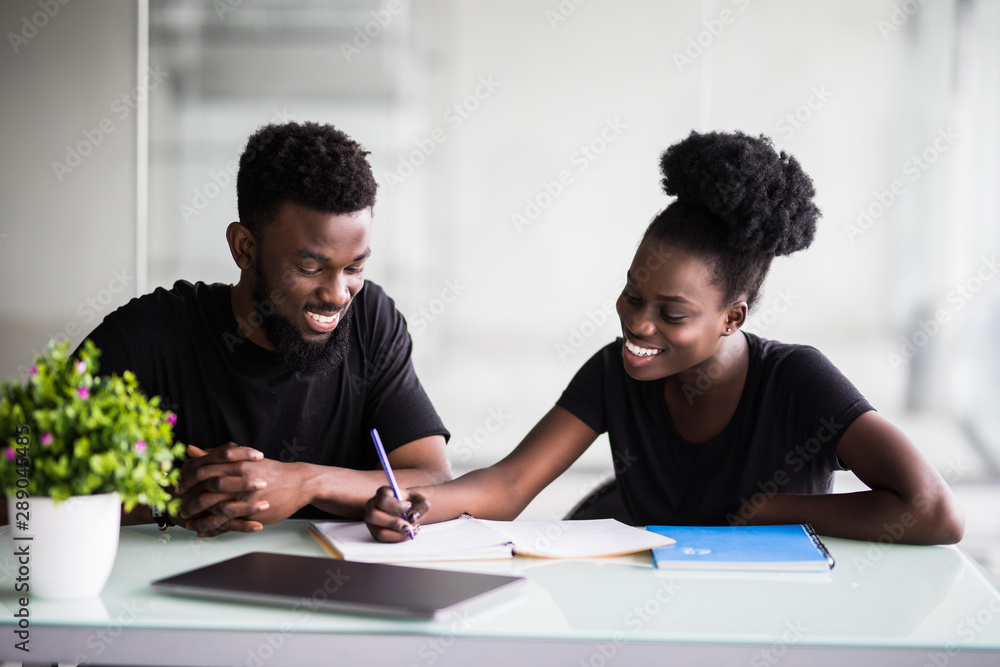 Two young african business collegue working together in office Two young african business collegue working together in office