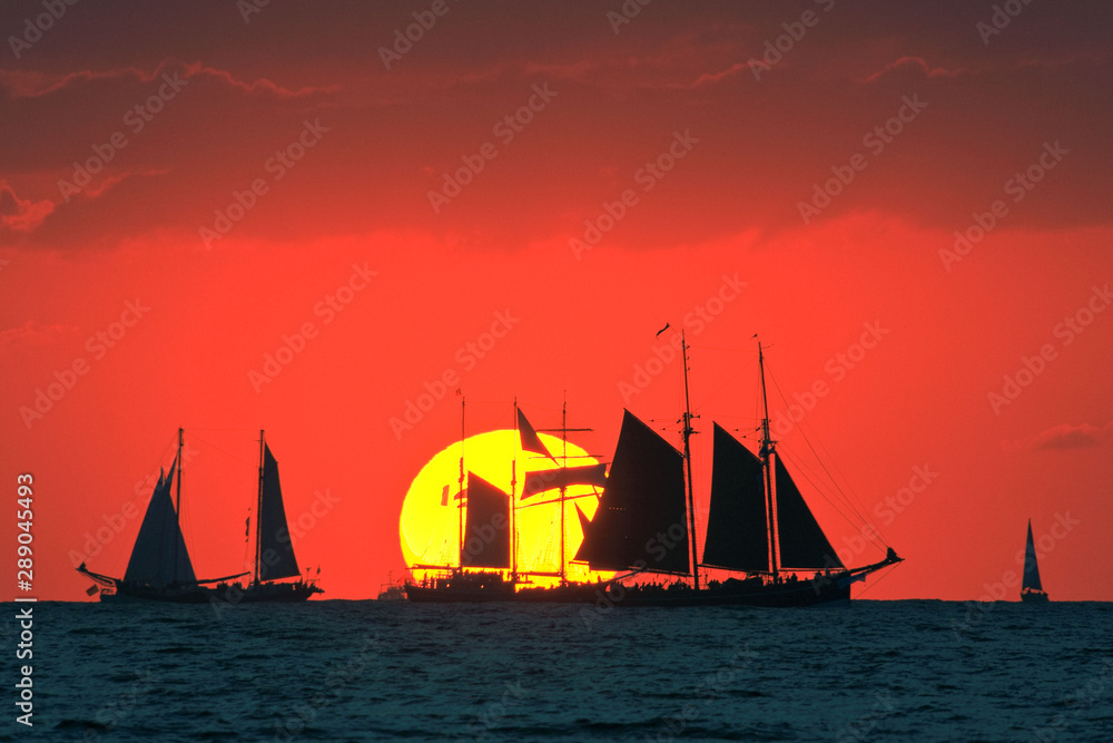 Traditional sailing ships at sunset on the Baltic Sea. Regatta 'Hanse Sail' near Rostock Warnemünde.