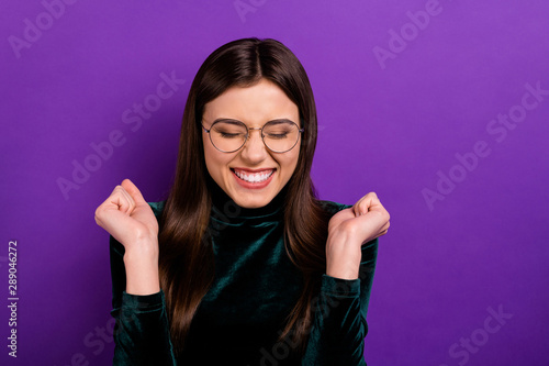 Canvas Print Close up photo of cute funny lady with closed eyes raising fists having eyewear