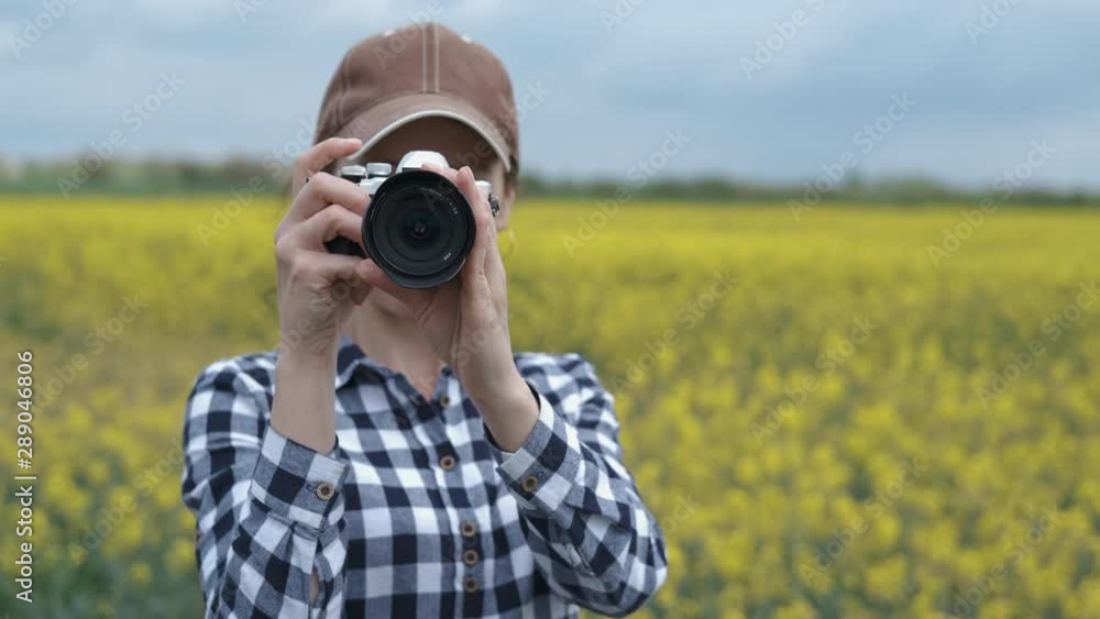 Woman photographer with camera in the countryside. Woman photographer with camera in the countryside.