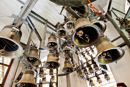 Close-up view of metal orthodox church bells in tower.