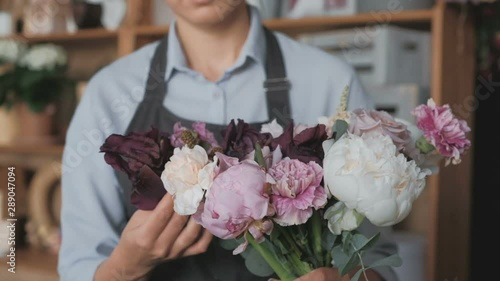 Florist making fresh flower bouquet in flower shop