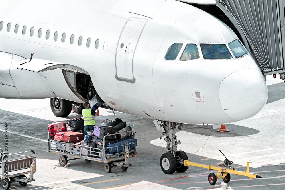 airplane on airport runway baggage loading for departure nose cockpit
