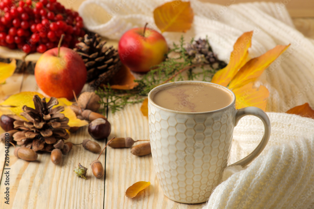 Hot autumn drink, coffee or cocoa, with yellow leaves and decorative pumpkins, acorns and apples on a natural wooden table. autumn composition. Hot autumn drink, coffee or cocoa, with yellow leaves and decorative pumpkins, acorns and apples on a natural wooden table. autumn composition.