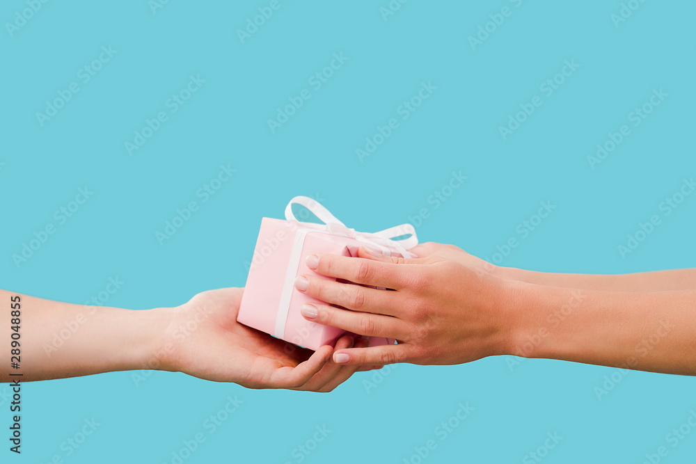 cropped view of couple holding present isolated on blue cropped view of couple holding present isolated on blue