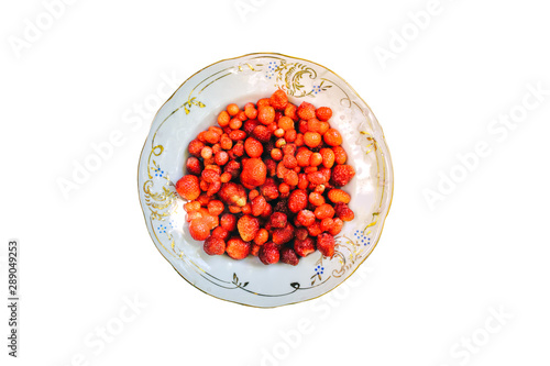 Vintage plate with home strawberries isolated on white background. Healthy vegetarian ecological food lifestyle concept.