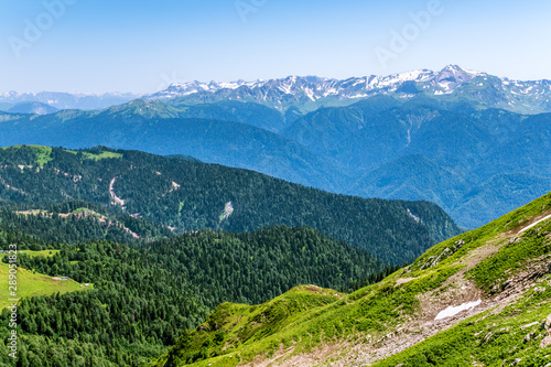 View over the Green Valley, surrounded by high mountains on a clear summer day © Dmitrii Potashkin
