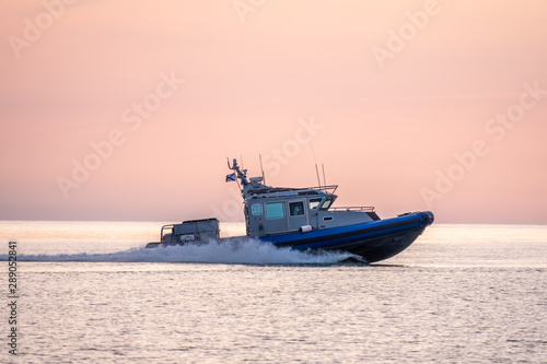 A coast guard patrol boat sails near the shore © Dmitrii Potashkin