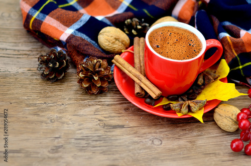 Autumn coffee. Concept of morning coffee. Morning autumn coffee background with leaves, cones and nuts on a wood