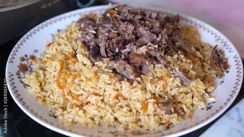 Plov traditional dish from Uzbekistan. The main course typically made with rice, pieces of meat, grated carrots and onions. Plov traditional dish from Uzbekistan. The main course typically made with rice, pieces of meat, grated carrots and onions.