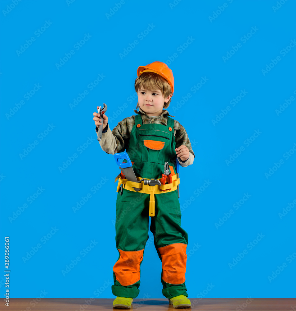 Repair concepr. Little boy with toy helmet and tools. Construction worker. Builder. Little repairman. Child game. Tools for building. Kid playing with repair tools. Repair concepr. Little boy with toy helmet and tools. Construction worker. Builder. Little repairman. Child game. Tools for building. Kid playing with repair tools.