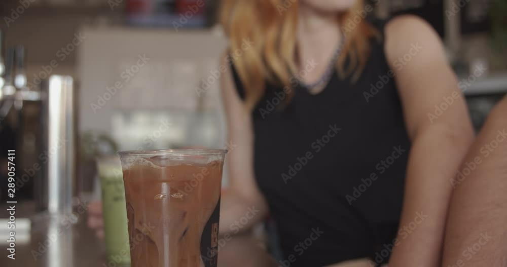 Beautiful Redhead Woman Sitting at Cafe in City Beautiful Redhead Woman Sitting at Cafe in City