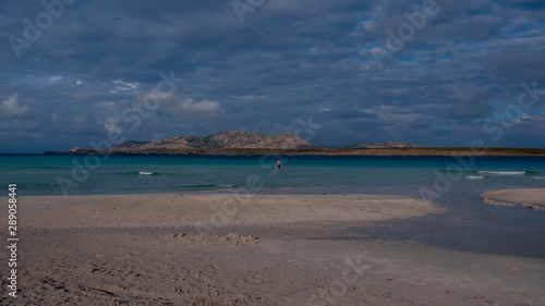 Beach with shallow water  clody sky  Italy