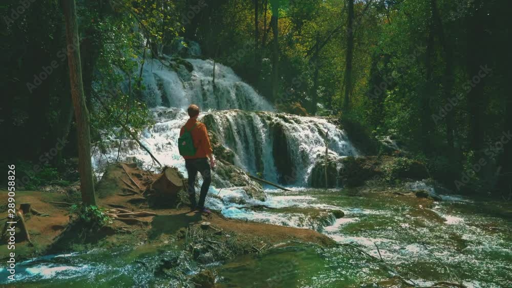 Beautiful 4K UHD Cinemagraph of waterfalls in Krka National Park in Croatia in early summer with a young man. Beautiful 4K UHD Cinemagraph of waterfalls in Krka National Park in Croatia in early summer with a young man.