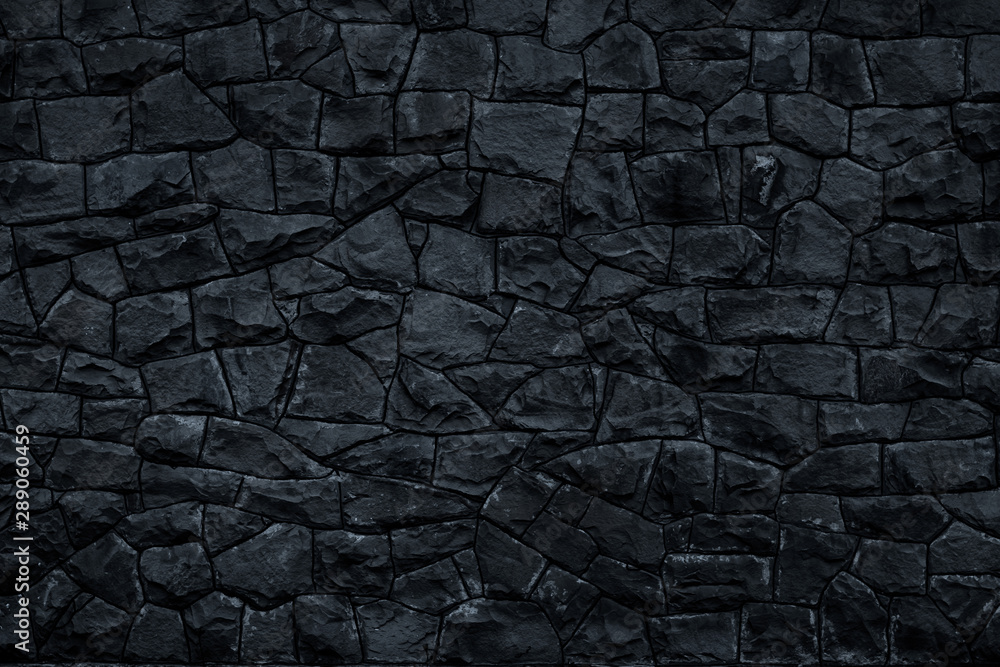 Dark stone background. Black rock wall texture. Abstract pattern