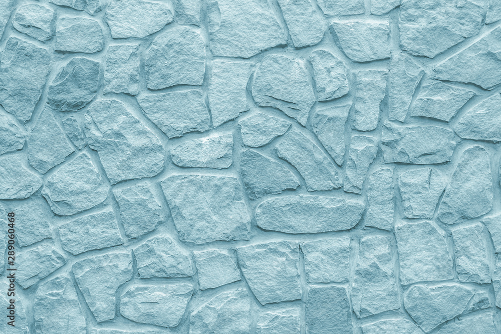 Cobblestones wall, gray background. Light blue texture of stone wall