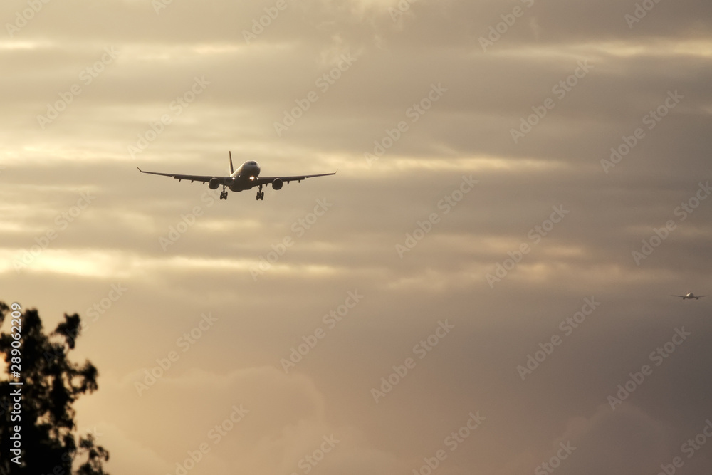 air plane in sunset sky