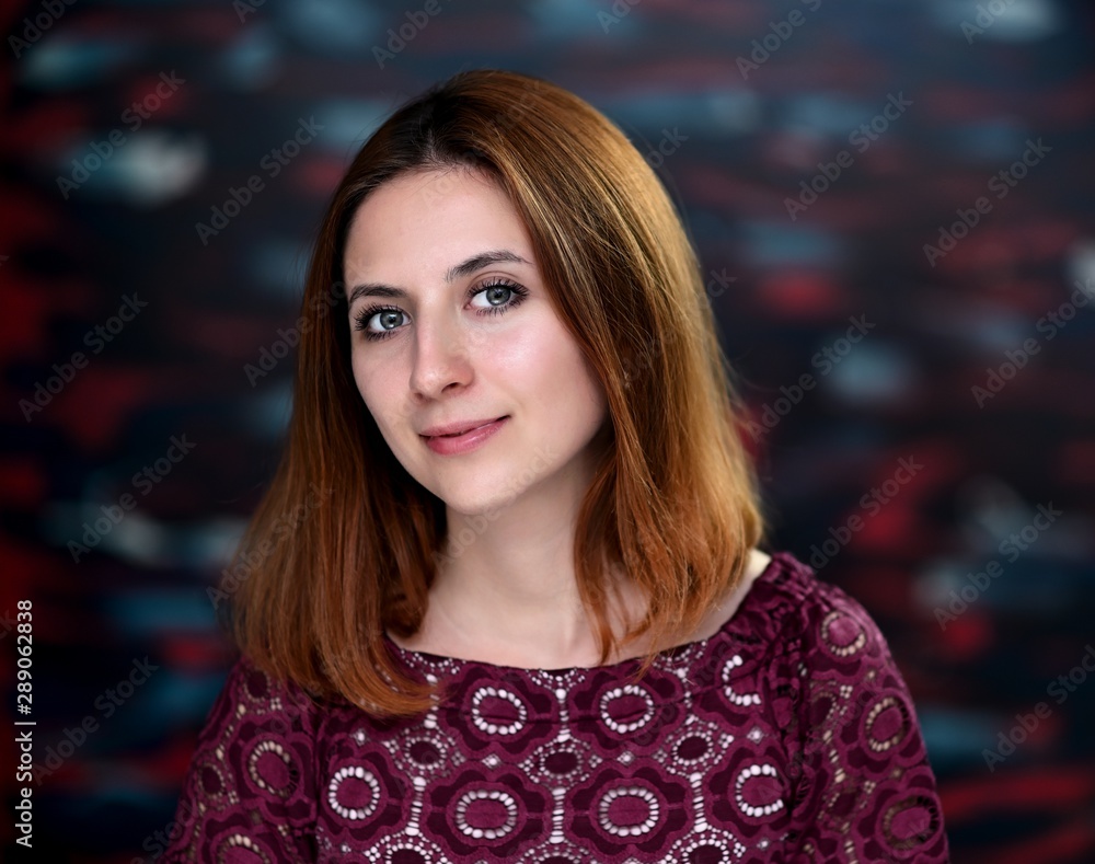 A close-up portrait of a pretty brunette girl with beautiful brown hair and excellent skin on a colorful background. Smiles, happiness, beauty. A close-up portrait of a pretty brunette girl with beautiful brown hair and excellent skin on a colorful background. Smiles, happiness, beauty.