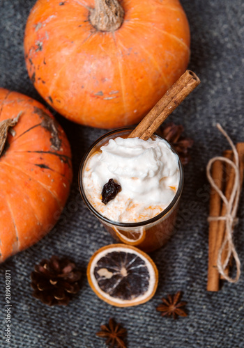 1 Cup pumpkin seeds juice with whipped cream and cinnamon, fresh whole pumpkin , slice susanoh of apelsina , top view