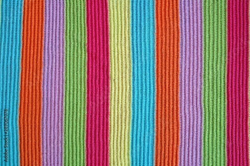multicolored woolen soft texture stripped. striped pattern fabric wool. multicolored woolen soft texture. knitted blanket from multi-colored threads. Knitted texture. Strips Backgrounds.