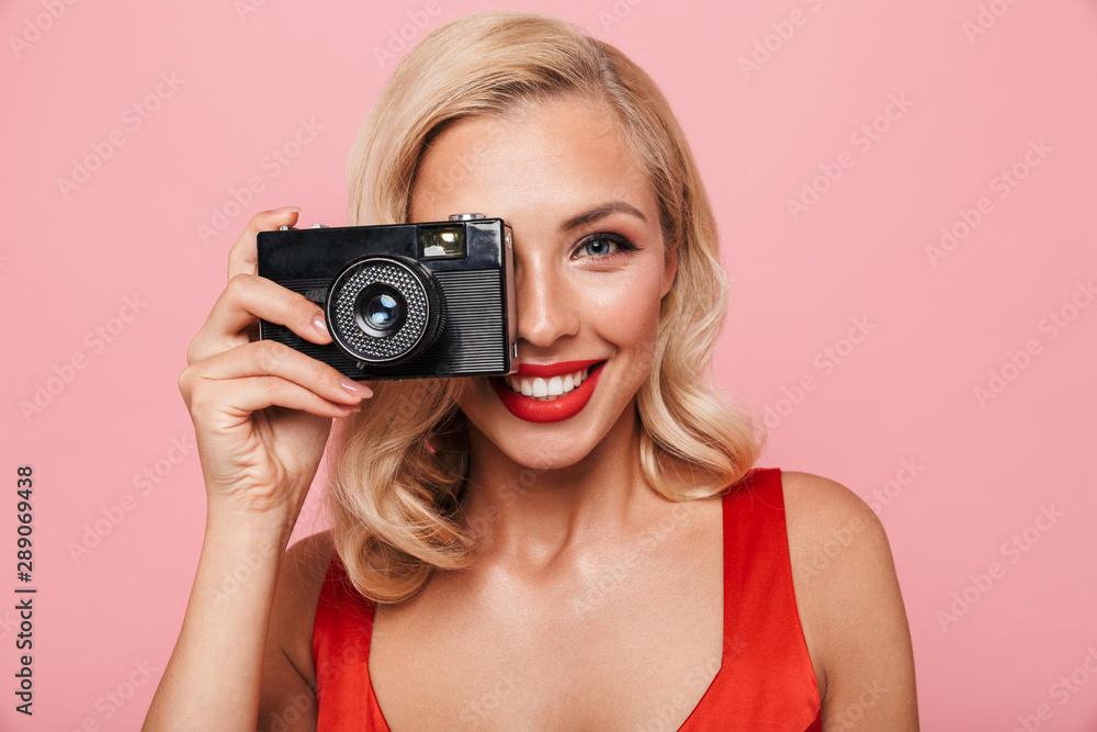 Beautiful young blonde woman wearing red dress standing Beautiful young blonde woman wearing red dress standing