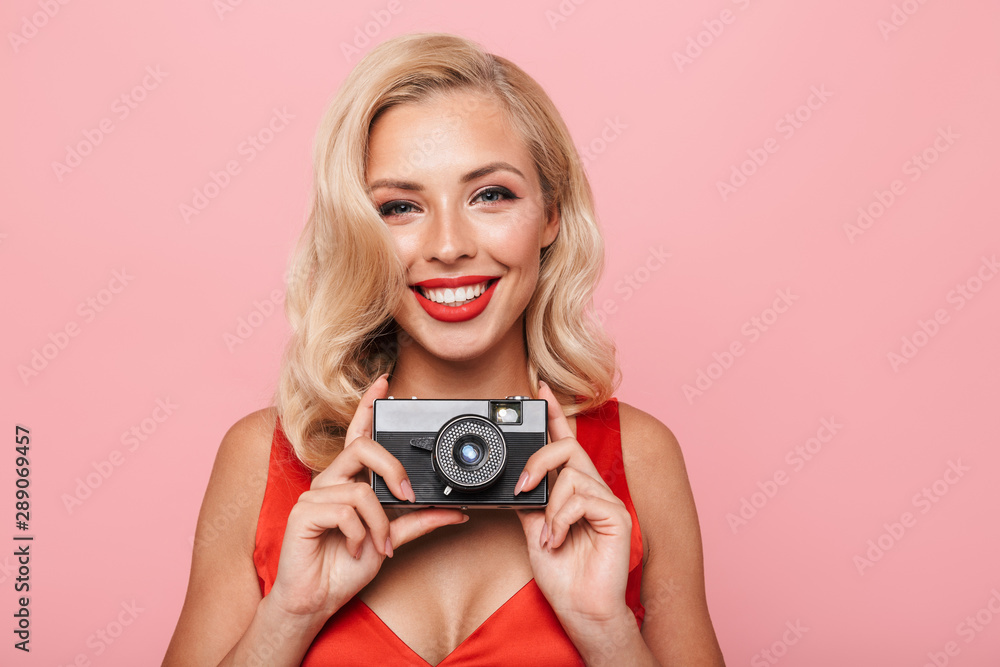 Beautiful young blonde woman wearing red dress standing Beautiful young blonde woman wearing red dress standing