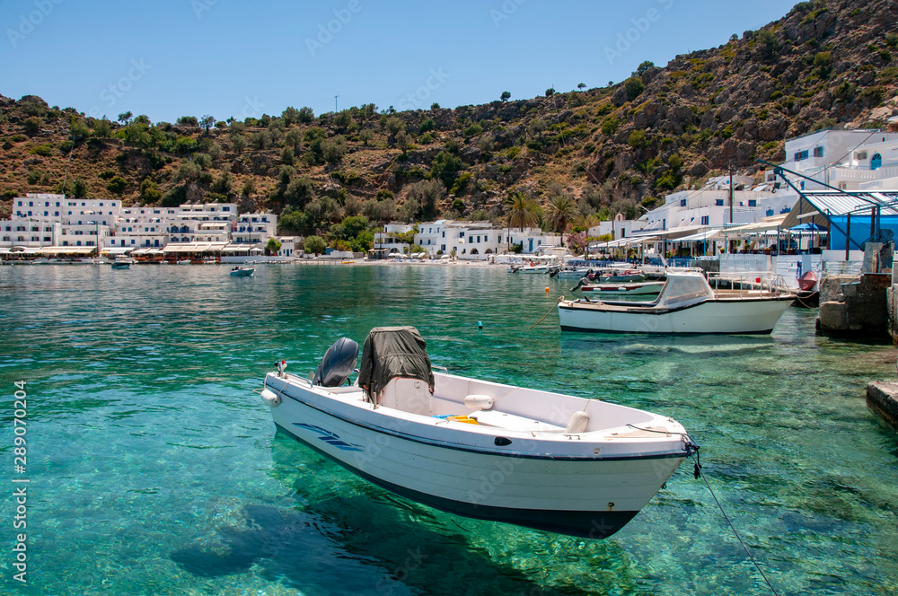 Small boats in the picturesque harbour of Loutro on the Greek island of Crete with turquoise waters and white washed buildings Small boats in the picturesque harbour of Loutro on the Greek island of Crete with turquoise waters and white washed buildings