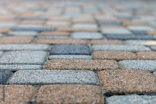 Side view of bright colored paving slabs with shallow depth of field. Blurred abstract texture background.