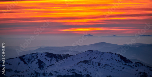 Aerial Landscape view from Ceahl  u Mountains National Park at sunset in winter season Sunset in Ceahlau Mountains