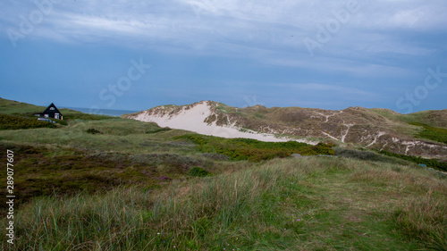 landscape lonely huse with rocks and blue sky  photo