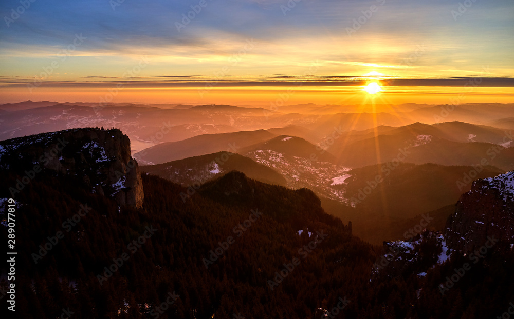 Aerial Landscape view from Ceahlău Mountains National Park at sunrise with fog in the winter season,sunrise in Ceahlau Mountains