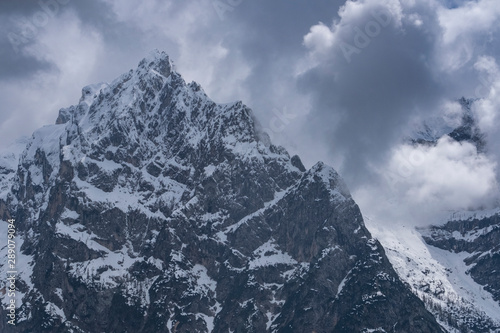 Alpine snow peak against a gloomy sky © YURII Seleznov