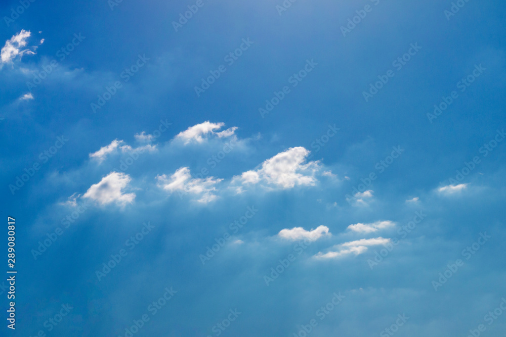 Several light white fluffy clouds on a blue sky background Several light white fluffy clouds on a blue sky background