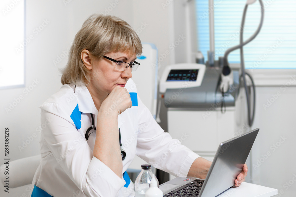 The female doctor is in the doctor's office with medical equipment The female doctor is in the doctor's office with medical equipment