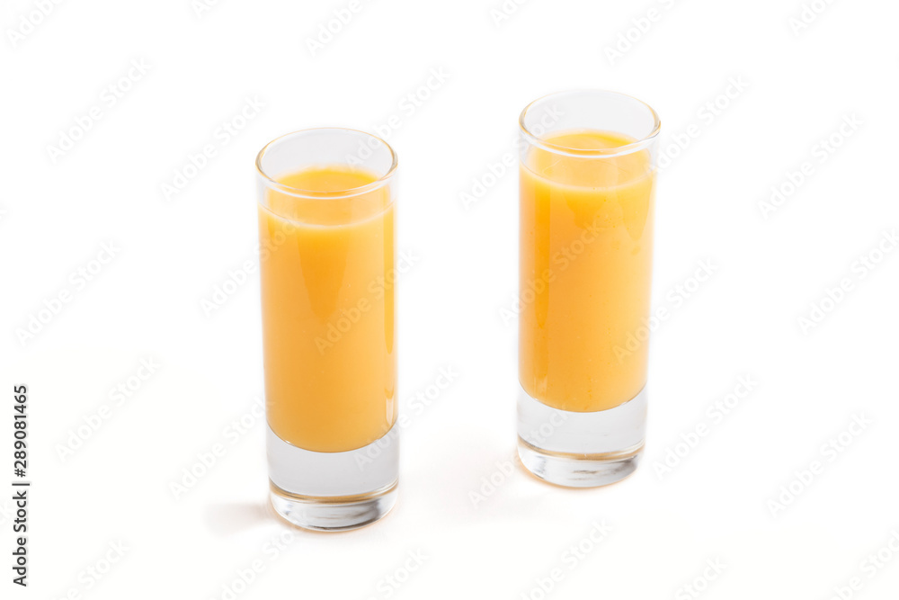 Sweet egg liqueur in glass isolated on white background. Side view Sweet egg liqueur in glass isolated on white background. Side view