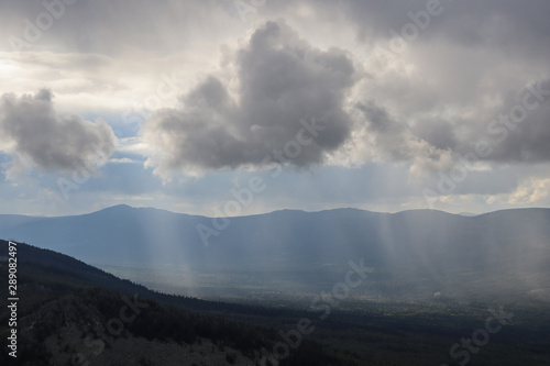 Rain, sun rays and clouds in the Ural mountains