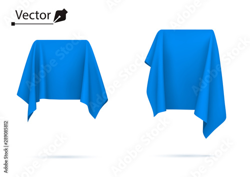 Object covered with blue silk cloth. Box, cube. Surprise, award, prize, presentation concept. Reveal a hidden object. 