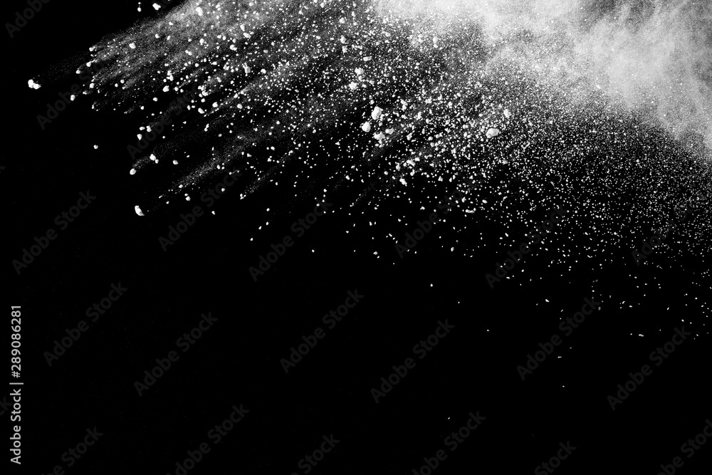White powder explosion isolated on black background. White dust particles splash. White powder explosion isolated on black background. White dust particles splash.