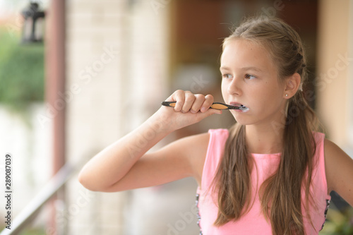 portrait of young woman cleaning tooths