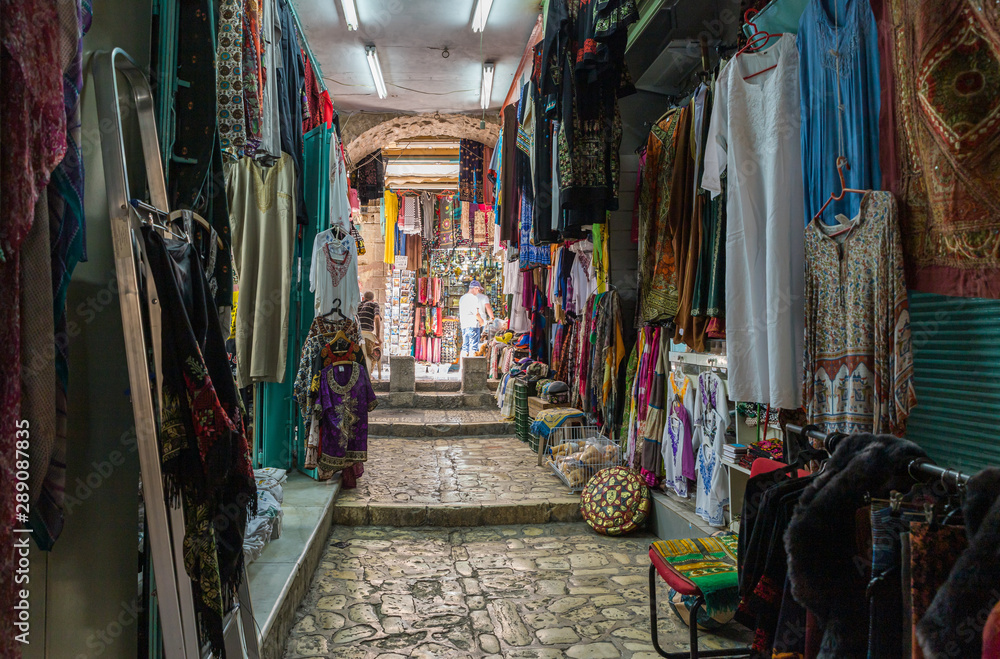 Arab bazaar with clothes located on a quiet street of the Old City in Jerusalem, Israel