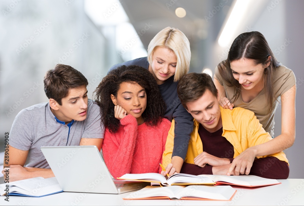 Four Young students studying subject on background Four Young students studying subject on background