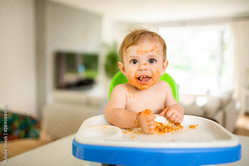 A Little baby eating her dinner and making a mess A Little baby eating her dinner and making a mess