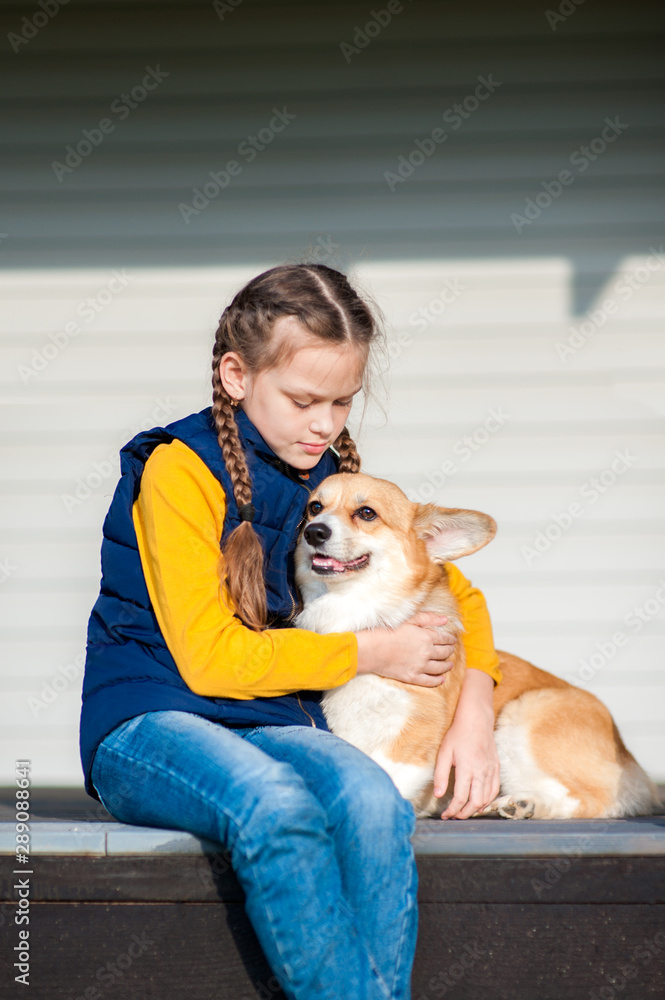 Girl sitting with a Corgi dog Girl sitting with a Corgi dog