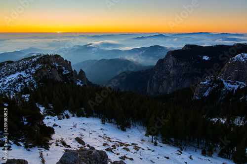 Fototapeta Naklejka Na Ścianę i Meble -  Aerial Landscape view from Ceahlău Mountains National Park at sunset in winter season,Sunset in Ceahlau Mountains