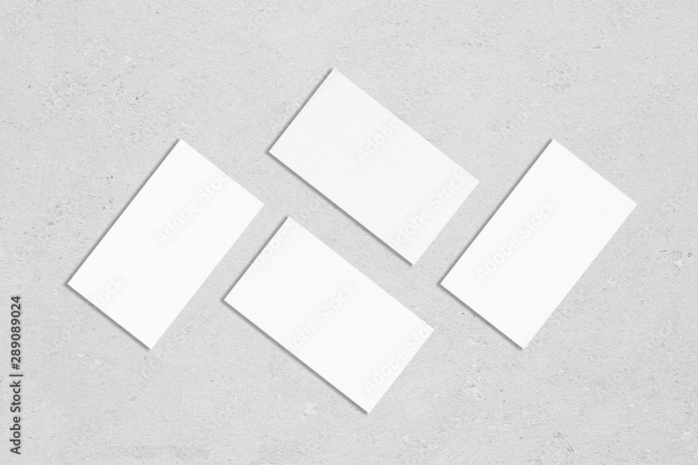 Stockfoto Four white rectangle business card mockups with soft shadows  lying on grey concrete background. Flat lay, top view | Adobe Stock
