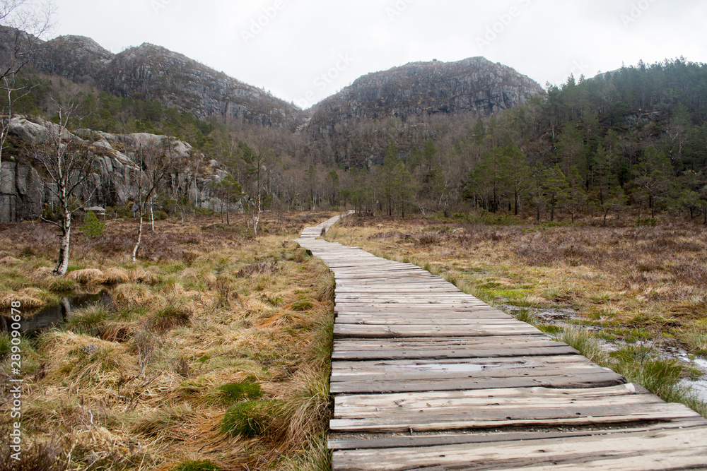 Start of the hiking trail to Preikestolen in Norway, wooden planks path as easy beginning Start of the hiking trail to Preikestolen in Norway, wooden planks path as easy beginning