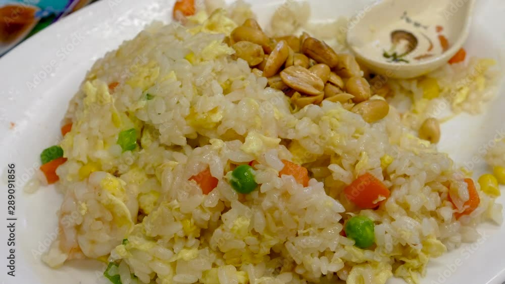 Dishing up Cantonese fried rice with peanuts Dishing up Cantonese fried rice with peanuts